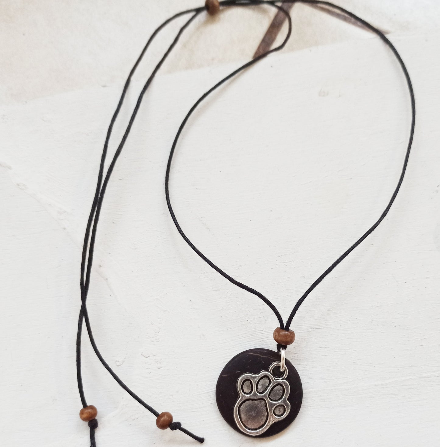Dog Paw Print Silver Charm on Coconut Shell Backing Necklace. Pendant for a dog lover.