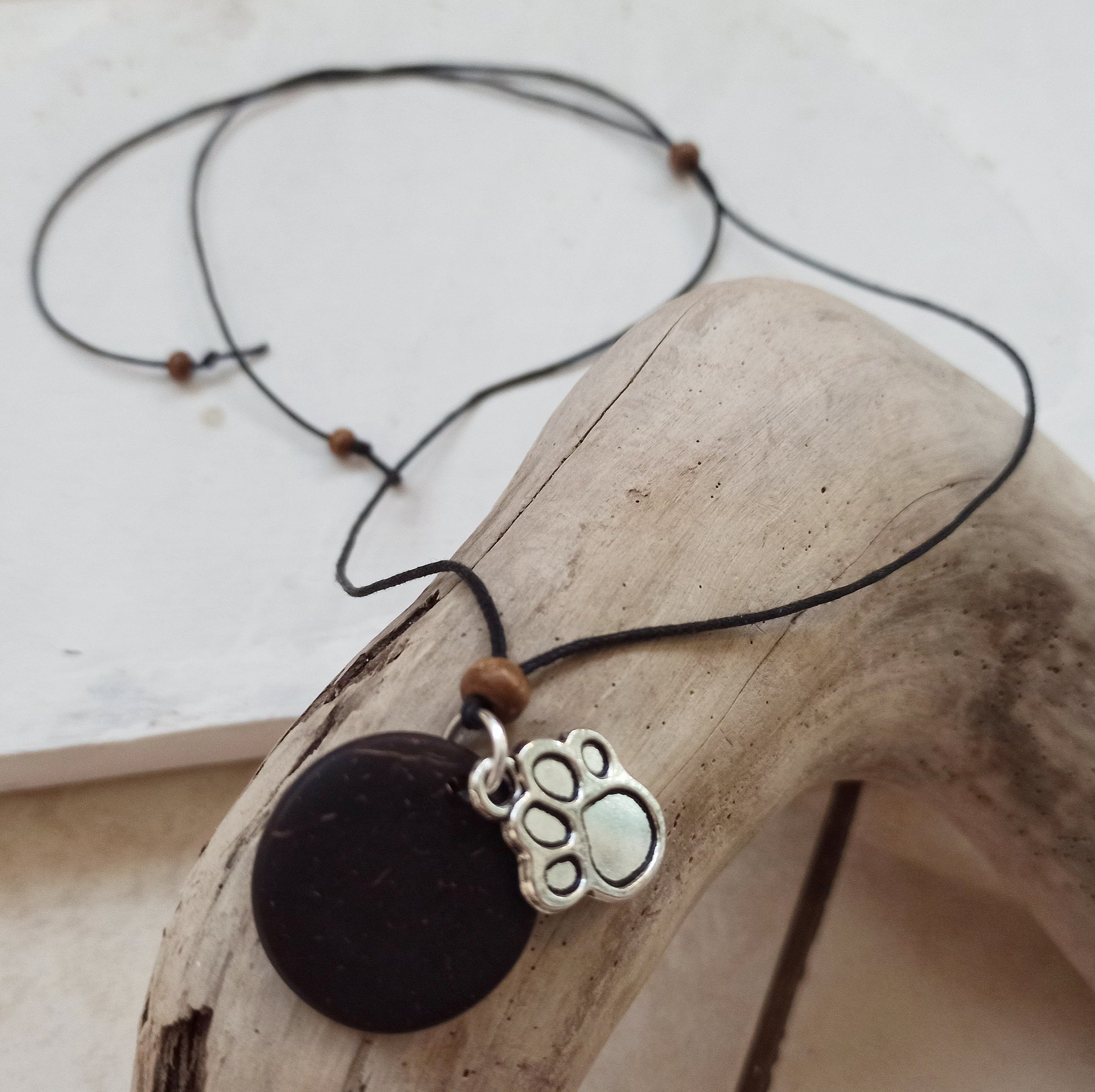 Dog Paw Print Silver Charm on Coconut Shell Backing Necklace. Pendant for a dog lover.